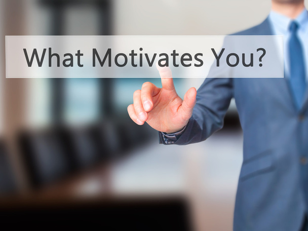 What Motivates You? - Businessman hand pressing button on touch  - Фото, зображення