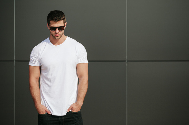 Hipster wearing white blank t-shirt with space for your logo - Photo, image