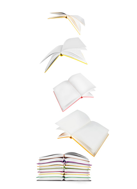 stack of books and flying books isolated on white - Zdjęcie, obraz