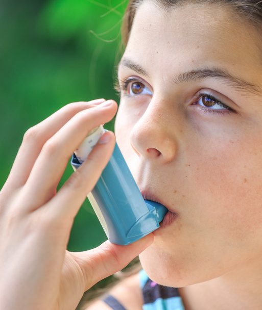 Portrait of a girl using asthma inhaler - Photo, Image