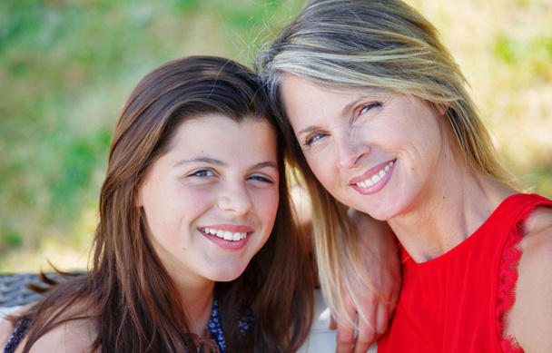 Mother and daughter hugging, smiling and sharing. Mothers day concept. Serenity and tranquility. - Photo, Image