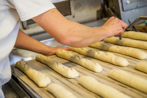 baker making bread with his hands - Foto, Bild