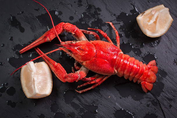 fresh boiled crawfish on the old wooden background - Foto, afbeelding