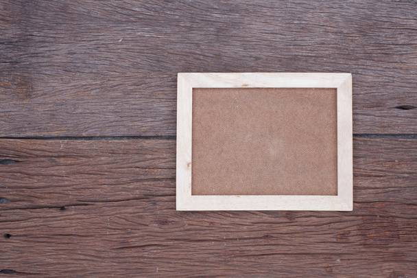 Blank wooden picture frame on wood table - Foto, Imagen
