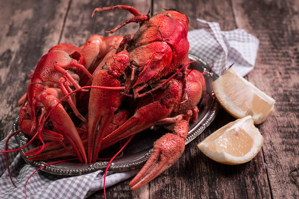 fresh boiled crawfish on the old wooden background - Foto, afbeelding
