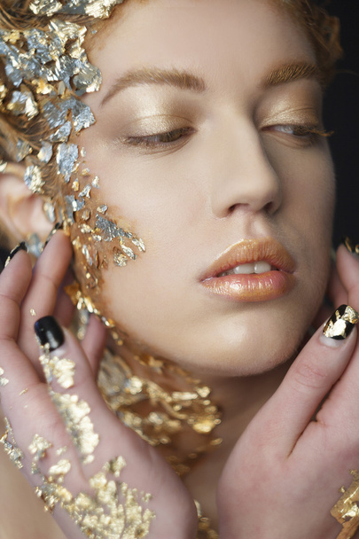 Portrait of beautiful sexy model with gold foil on her face - Photo, image