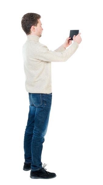 back view of standing business man photographing a phone or tabl - Foto, Imagem