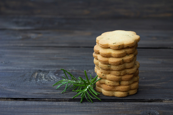 Homemade cookies with rosemary on a wooden surface - Photo, image