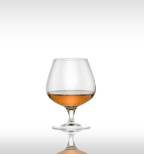 Cognac glass with brandy on a white background. - Photo, image