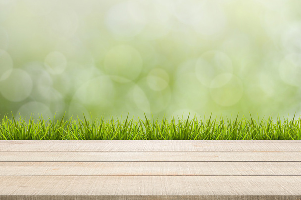 painel superior de mesa de madeira e grama no fundo verde
 - Foto, Imagem