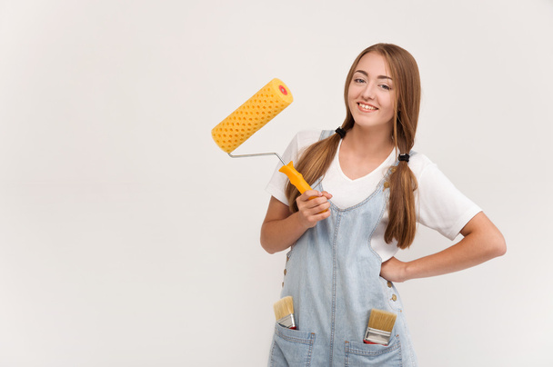 young girl holding a paint roller - Foto, Imagem