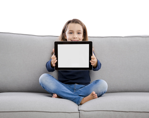 girl on couch showing tablet - Фото, зображення