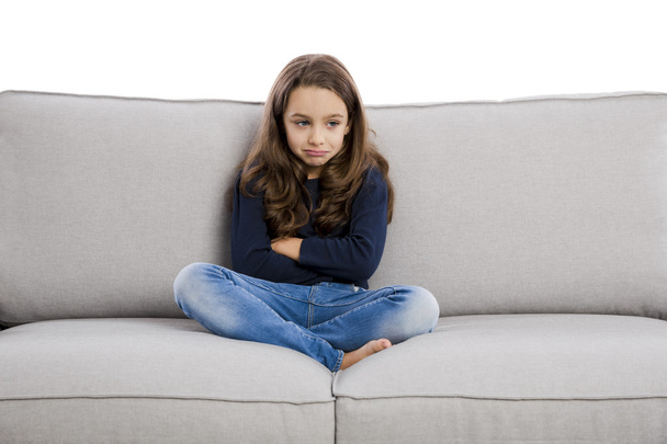girl sitting on couch upset  - Фото, зображення