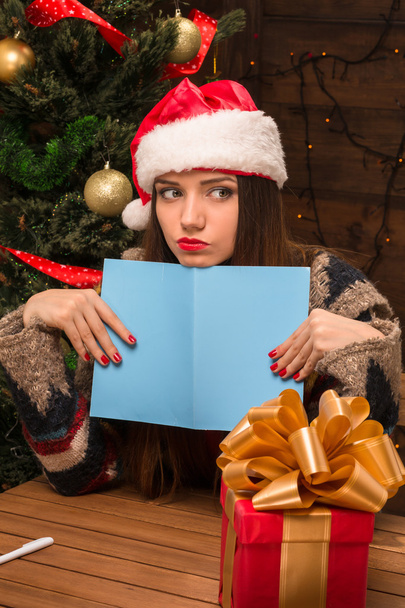 Beautiful girl holding a New Year and Christmas post card - Foto, afbeelding