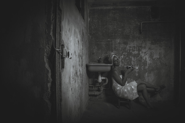 Cheap accommodation. Girl drinking tea in an old apartment. Blac - Fotó, kép