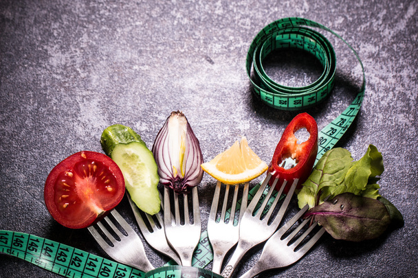 Fresh mixed vegetables on fork ,black background - Foto, Imagen