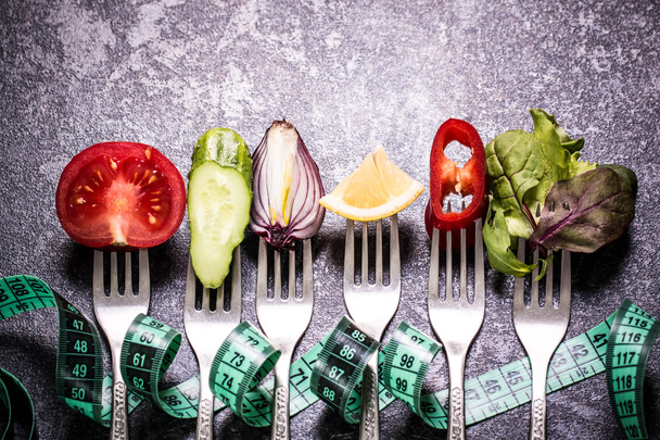 Fresh mixed vegetables on fork ,black background - Photo, image