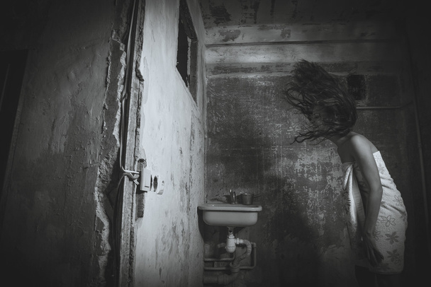 Cheap accommodation. She dries her head. Black and white photogr - 写真・画像