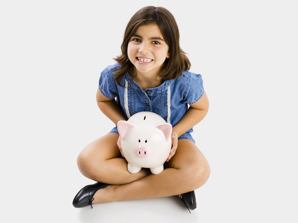 girl holding a piggybank - 写真・画像