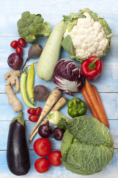 Vegetables on a blue wooden board, top view - Fotó, kép