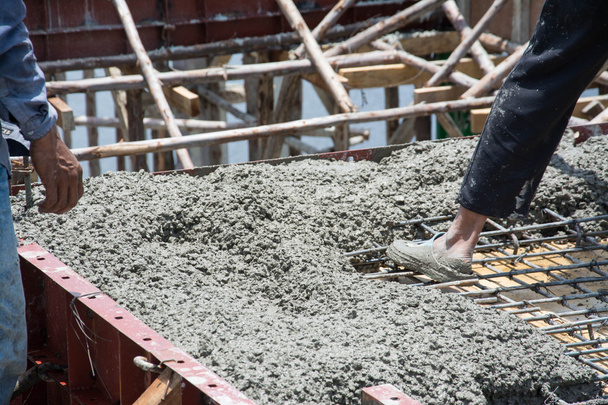 worker pouring concrete works at construction site  - Foto, Imagem