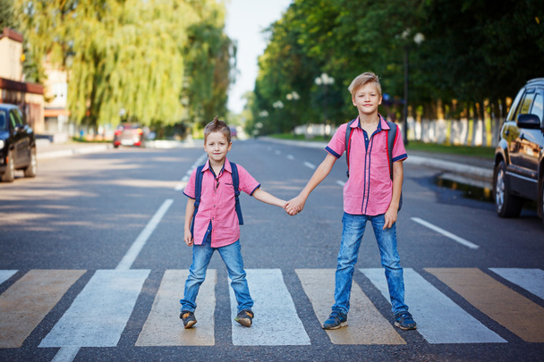Kids with backpack walking, holding on warm day  on the road . - Photo, image