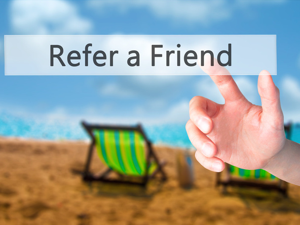 Refer a Friend - Hand pressing a button on blurred background co - Photo, Image