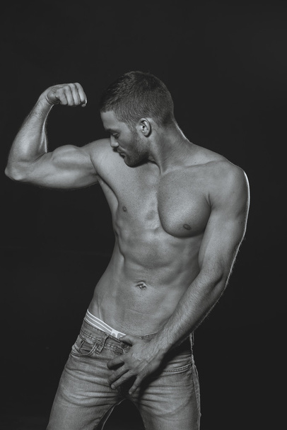 black and white photography. Model. Athletic guy with a naked bo - Foto, imagen
