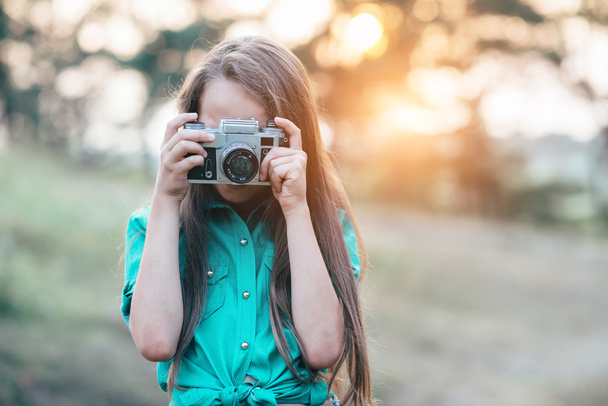 Portrait of a pretty little brunette girl smiling and holding a  - Foto, Imagem