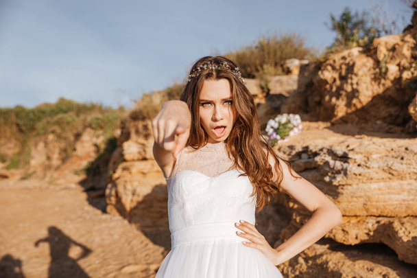 Young beautiful bride pointing finger at you - 写真・画像