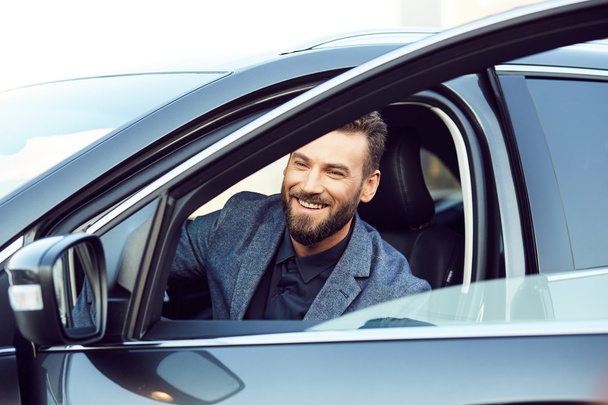 Attractive smiling young man in a car - Φωτογραφία, εικόνα
