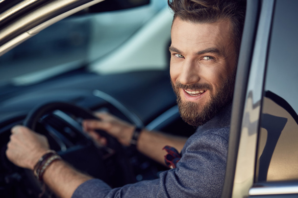 Attractive elegant smiling man in good car - Fotó, kép