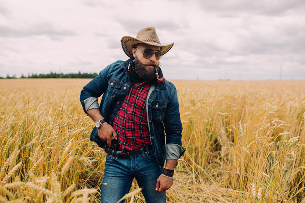 Bearded man in field - Фото, изображение