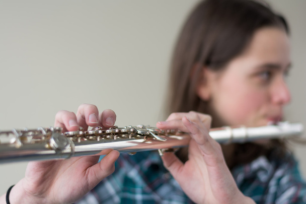 youth flute player - focused instrument - Photo, Image