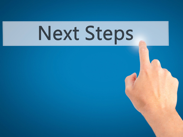 Next Steps - Hand pressing a button on blurred background concep - Φωτογραφία, εικόνα