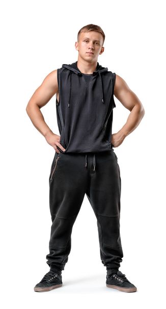 Full lenght portrait of muscled young man with his hands on hips - Foto, afbeelding