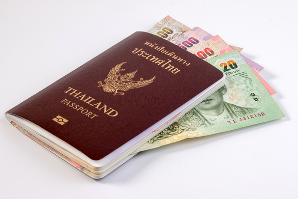 Pasaporte tailandés con billete de dinero tailandés y moneda tailandesa aislada en blanco. El pasaporte del ciudadano tailandés en billete tailandés
. - Foto, imagen