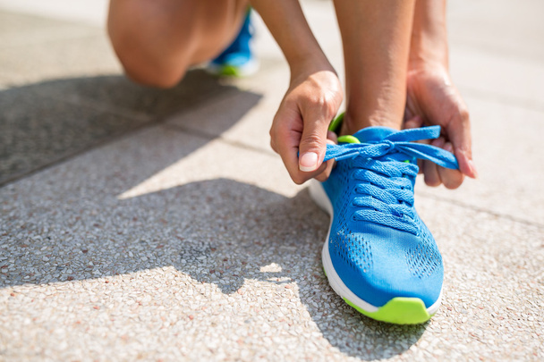 Woman tying laces for jogging - Photo, Image