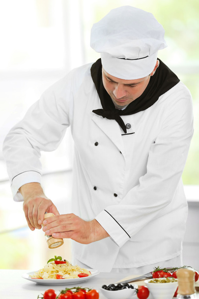 Chef preparing delicious pasta - Fotó, kép