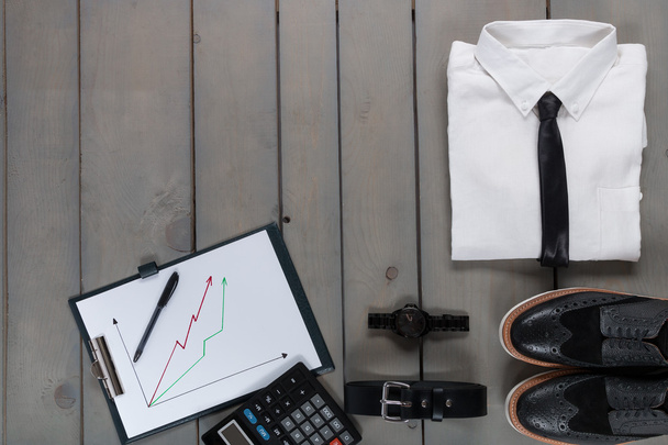 Businessman, work outfit on grey wooden background. White shirt with black tie, watch, belt, oxford shoes, planchette and calculator. Back to . Copy space, frame. Set of mans fashion  accessories. - Photo, Image