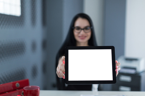 young business woman in office holding a tablet and smiling - Foto, immagini