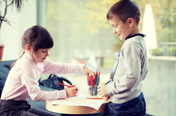 happy little girl and boy drawing at home - Фото, изображение