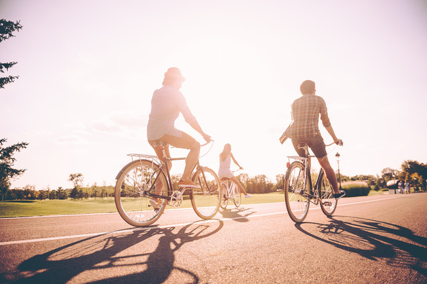 cheerful people riding bicycles - Foto, Bild