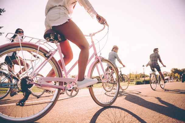  cheerful people riding bicycles  - Foto, Bild