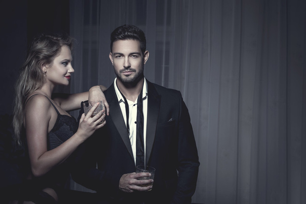 Rich macho young man drink whiskey with lover - Photo, Image