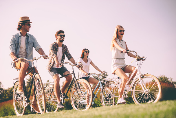 Group of young people riding bicycles  - Foto, Bild