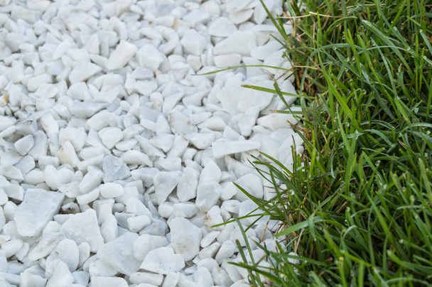 background track from white stones, near green grass lawn - Φωτογραφία, εικόνα