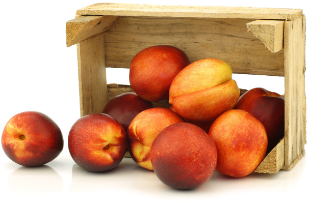 Fresh nectarines in a wooden crate - Photo, Image