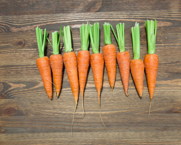 Fresh carrots at wooden table - Foto, immagini