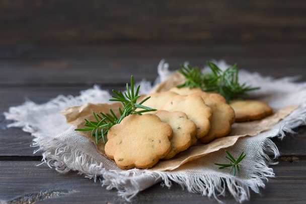 Homemade cookies with rosemary on a wooden surface - 写真・画像